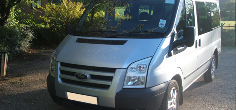 Silver Ford mini bus